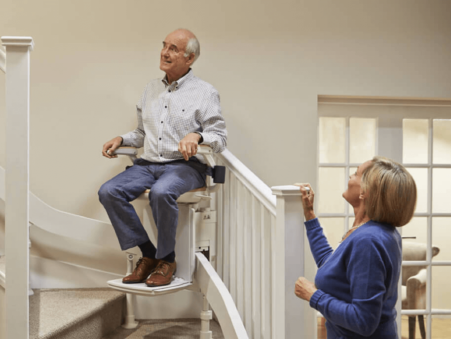 Senior couple testing out their Acorn Stairlift