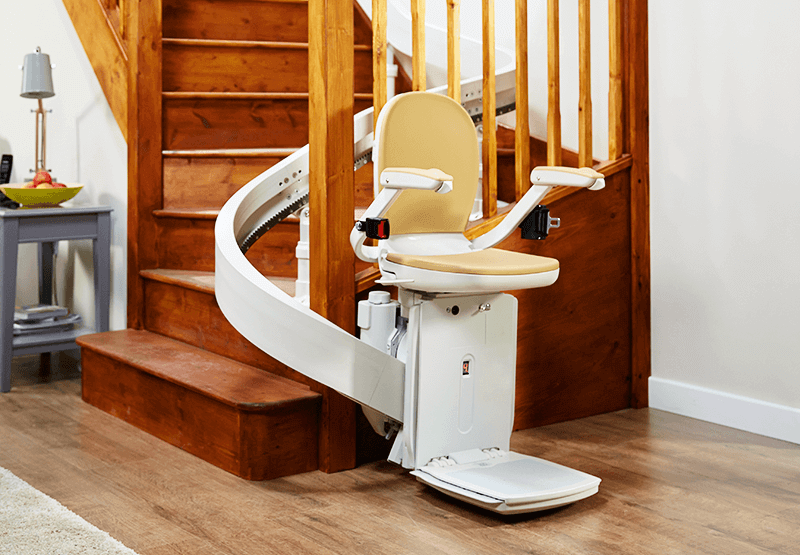 Image of Curved Stairlift in Use At Bottom Of Stairs