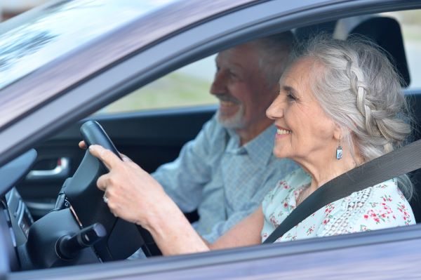 Senior couple driving behind the wheel